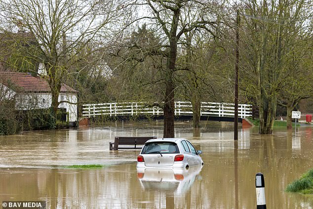 If the AMOC collapses, people in the UK would die from stronger winter storms and flooding, and many old and young would be vulnerable to very cold winter temperatures. Pictured: A flooded street in Alconbury Weston in Cambridgeshire this month