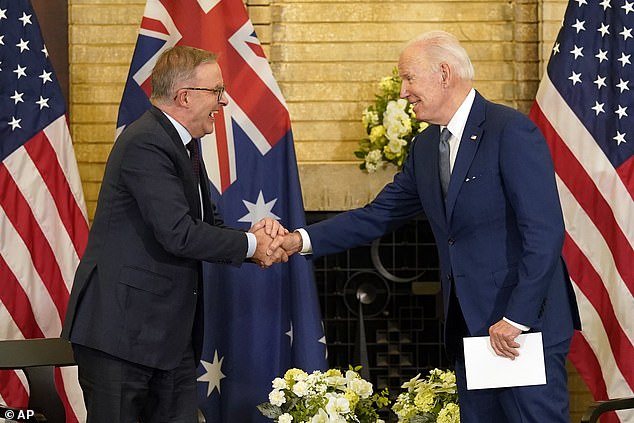 Australian Prime Minister Anthony Albanese (L) shakes hands with US President Joe Biden (R) at the Quad leaders' summit on Tuesday, May 24, 2022, in Tokyo.