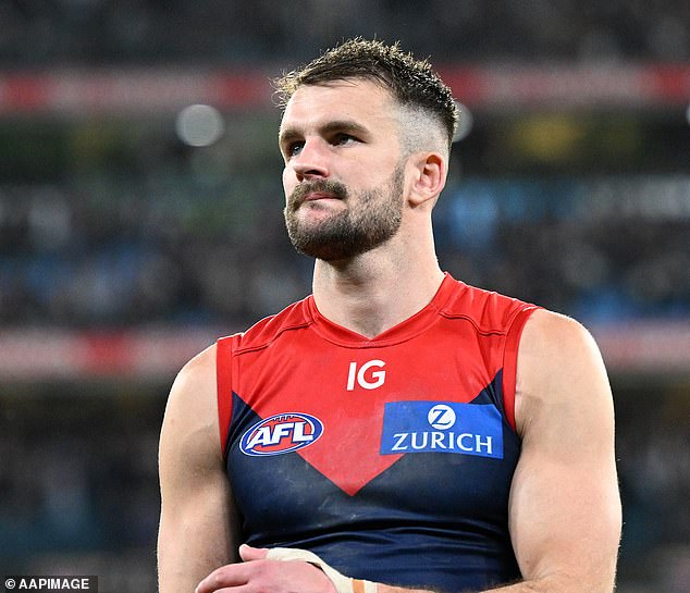 100 AFL players have reportedly been granted secret immunity from the sport's three strikes policy (pictured Melbourne Demons star Joel Smith, who tested positive for cocaine on the day of the game last year).