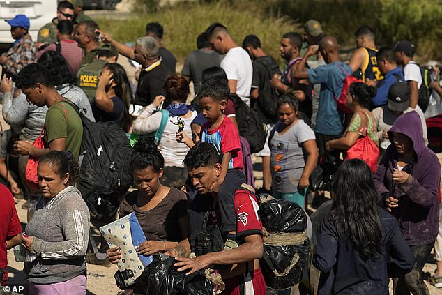 Migrants wait to be processed by U.S. Customs and Border Patrol after crossing the Rio Grande and entering the U.S. from Mexico, Oct. 19, 2023, in Eagle Pass, Texas.