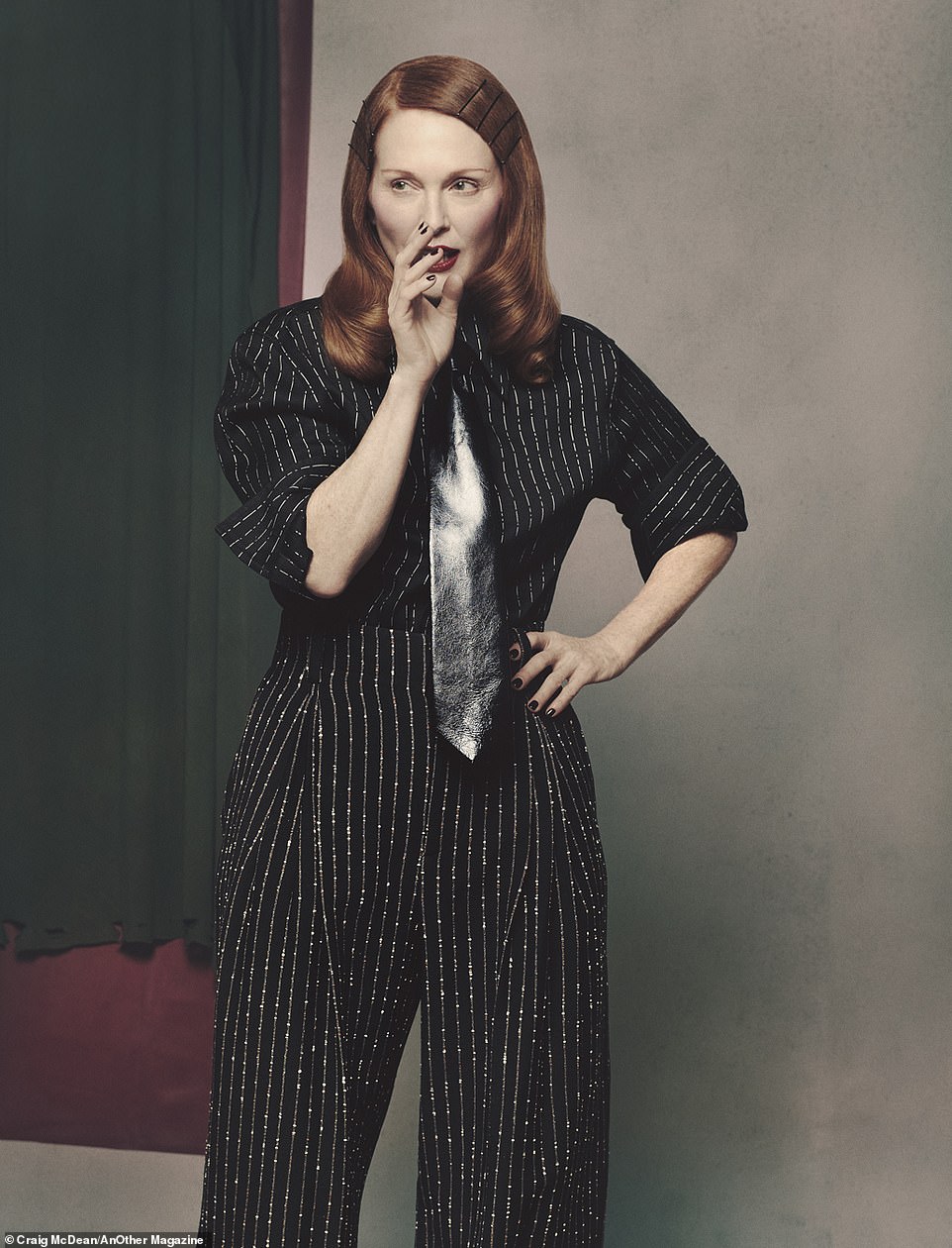 Julianne appears to be up to something in a Bottega Veneta top and pants.