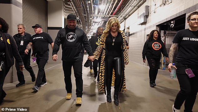 Footage was played showing Garth and Trisha walking hand in hand backstage at one of their stadium shows, flanked by their entourage.