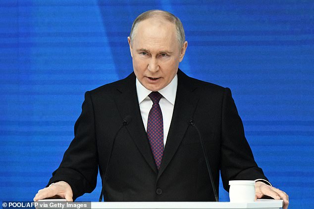 Vladimir Putin has been accused of fueling the migrant crisis to influence politics in Europe.  Pictured: Putin delivering his annual State of the Nation address in Moscow on Thursday.