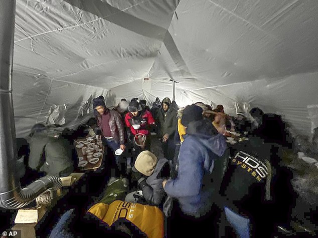 Migrants gather in a tent to get hot drinks near the Finnish border at the Salla checkpoint in November last year.