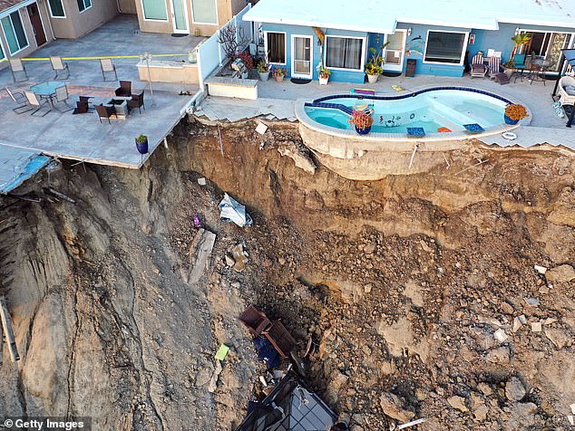An aerial view of a pool remaining on the edge of a hillside landslide triggered by heavy rain, which prompted the evacuation and closure of four ocean-view apartment buildings due to unstable conditions, on March 16, 2023 in San Clemente, California.