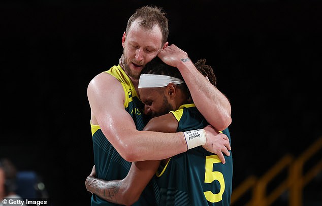 Joe Ingles and Patty Mills share an emotional moment after winning Australia's first Olympic medal at the Tokyo games.