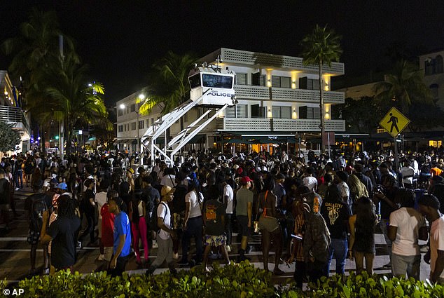 Visitors and residents can expect a significant police presence and strict enforcement of open container and noise laws during the peak spring break season in mid-March. Pictured: Crowds in Miami Beach after the two fatal shootings.