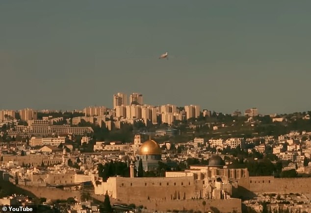 In the entry to Bashar Murad's 'Wild West', the pop star is seen driving through an orange grove in the West Bank, flying over the separation barrier in a plane and looking towards Jerusalem, specifically the golden dome of the Al-Aqsa Mosque.  in the eastern district of the city (pictured)