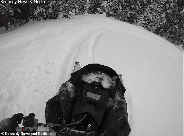 1709291231 311 Terrifying moment a snowmobiler and his friend are swallowed by