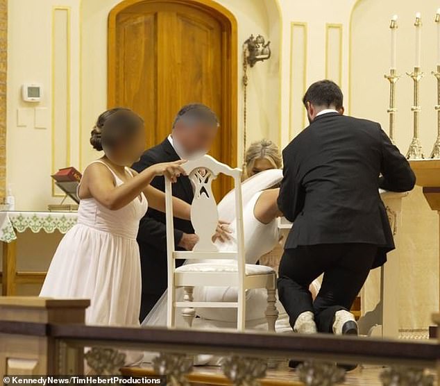 After Catherine collapsed, her husband and other wedding guests, including a bridesmaid, helped her into a chair.