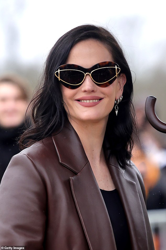 Eva's sunglasses were the real star of the show as she smiled while wearing the extravagant glasses.