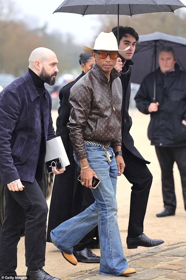 Pharrell Williams embraced his inner cowboy and arrived wearing a cream cowboy hat, Louis Vuitton leather jacket and flared jeans.