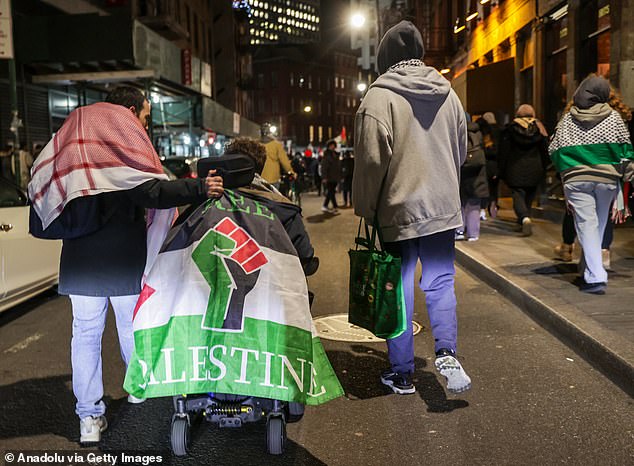 1709304377 534 Pro Palestinian protesters ride the famous Wall Street Bull and dare