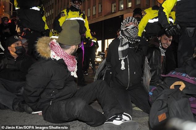 Members of the New York City Police Department arrest pro-Palestinian protesters during a march near City Hall.