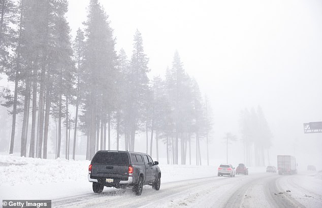According to the Weather Channel, the Sierra Nevada could soon be covered in 12 feet of snow along with strong winds (pictured in Kingvale, California on Thursday).