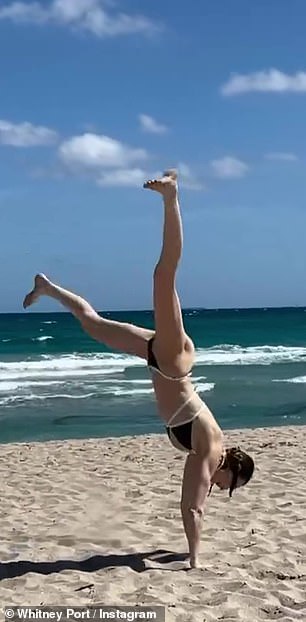 After running from near the shore, the mother of one did a cartwheel in her two-piece suit.
