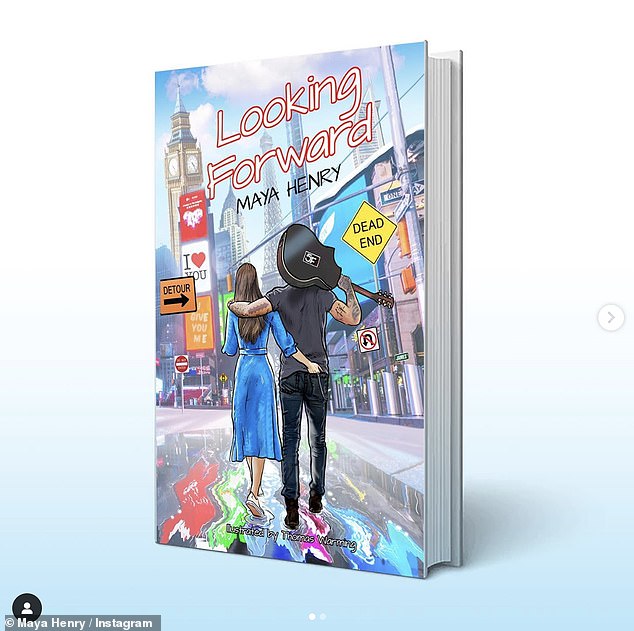 She shared a photo of the cover of the book, which is called Looking Forward, which shows a brunette woman and a man carrying a guitar, walking arm in arm in London.