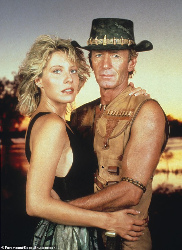 She is Crocodile Dundee star Linda Kozlowski. The film followed Kozlowski as a New York reporter who is sent to Australia to interview crocodile hunter Michael J. Dundee, played by 83-year-old Paul Hogan.
