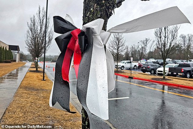 Red, black and white memorial ribbons were placed in front of the church before the service.