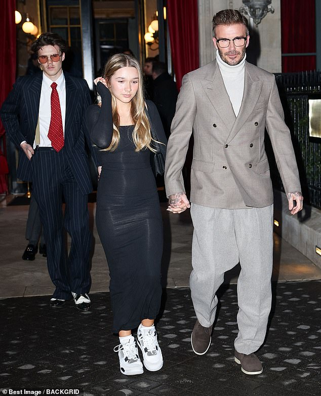 David, who walked hand in hand with his daughter, looked dapper for Victoria's big night in a beige double-breasted jacket which he teamed with a stylish fleece-collar sweater.