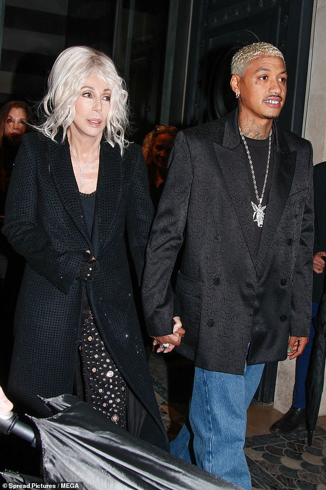 The iconic singer, known for her love of wigs, sported a bleached blonde beehive as she walked hand in hand with her beau.