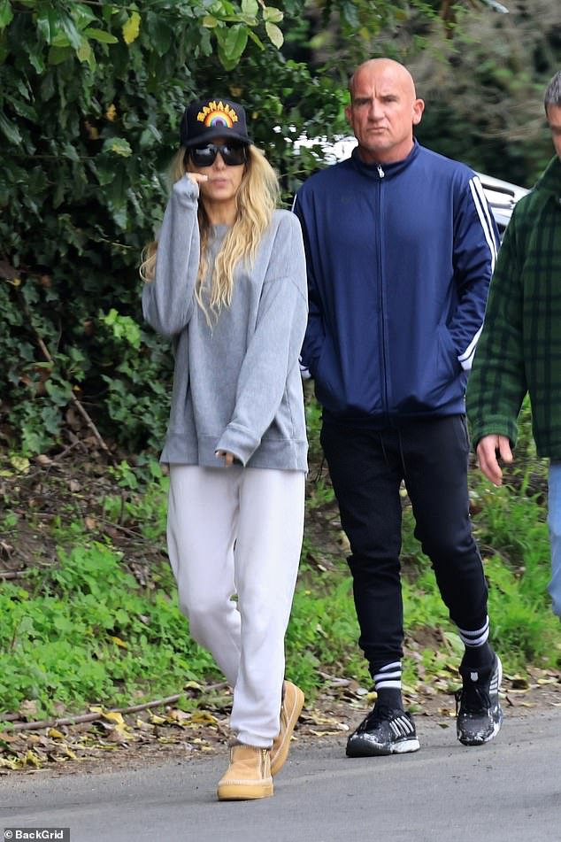 Tish rocked a casual look for the occasion, wearing a gray sweatshirt, white sweatpants, and UGG boots.