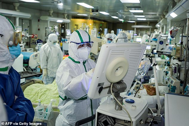This photo taken on February 24, 2020 shows medical staff treating patients infected with the COVID-19 coronavirus at a hospital in Wuhan, central China's Hubei Province.