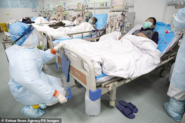 Medical workers perform hemodialysis treatment on a uremic patient recovering from COVID-19 infection at Hankou Hospital in Wuhan in March 2020.