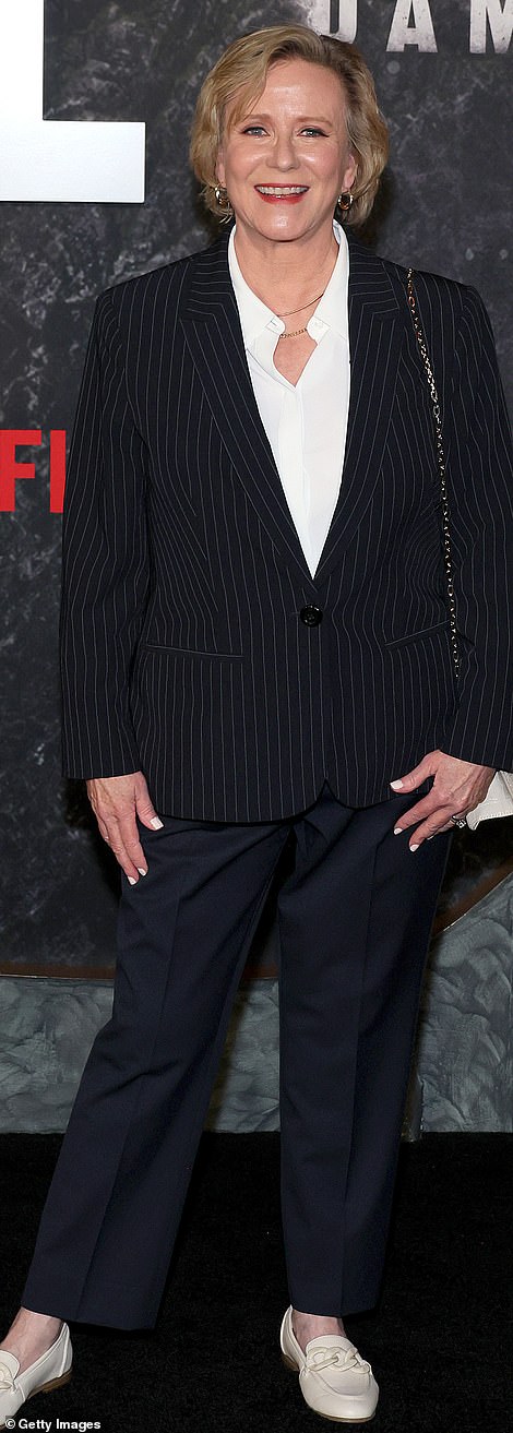 Eve Plumb opted for a mismatched look in a black coat and midnight blue pants.