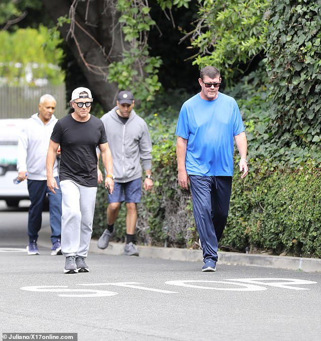 The 56-year-old was accompanied by friends and appeared relaxed as he went for a healthy walk on Friday.