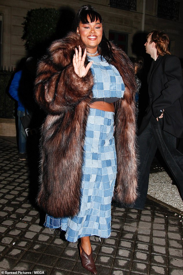 Precious Lee added a splash of color to the party as she showed off her mid-height in a blue patchwork-style two-piece suit worn under a long brown fur coat.