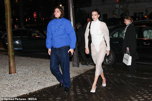 Amelia Gray Hamlin (right) caused a sensation when she was spotted leaving the party in a bizarre white leotard that she wore under a long-sleeved sheer white dress.