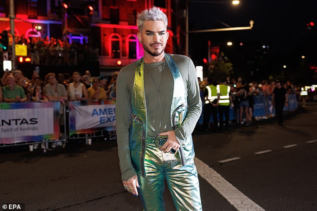 The 42-year-old opted for a shiny metallic vest that matched his trousers and a sparkly belt as he posed on a Sydney street amid the Pride event.