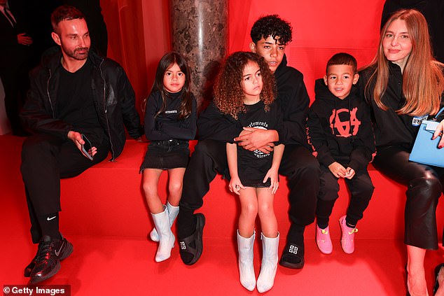 Georgina was also joined by the couple's children, Alana, five, Cristiano Jr, 13, and twins Eva Marie and Mateo, 6, (LR), who sat admiring the model's strut on the catwalk. .