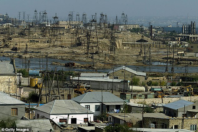 In the photo from 2003: a view of the oil wells.