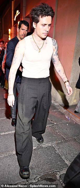 Brooklyn wore a white vest with elegant tailored pants.