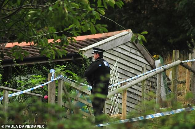 Police officers at the scene in Devon on the day Mr Rawley was found dead.