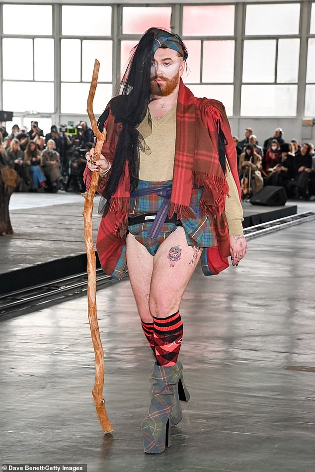 The Unholy hitmaker, 31, teamed the underwear with shiny red and black knee-high socks and green tartan platform heels as she walked with a wooden stick.