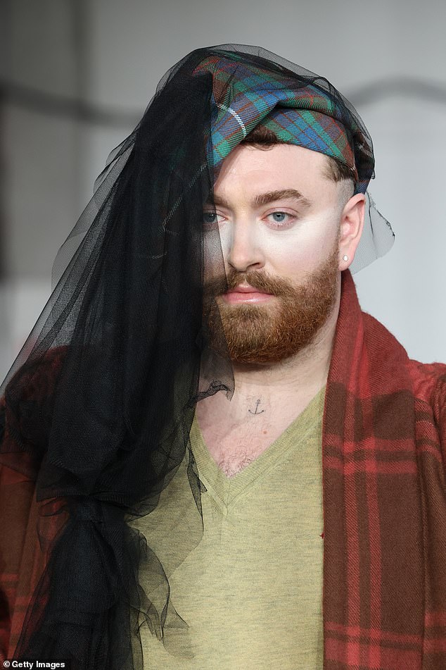 Sam completed the look with a quirky tartan headscarf, which matched the pattern of her underwear and extended into a sheer black scarf that covered half her face.