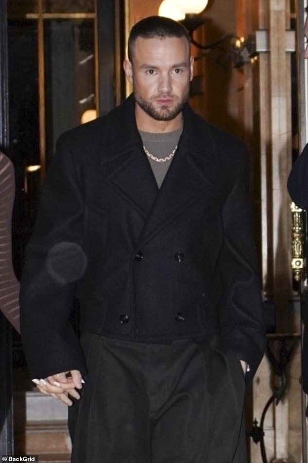 Meanwhile, Liam was wrapped up in a double-breasted wool coat which he wore with a pair of extravagant oversized trousers.