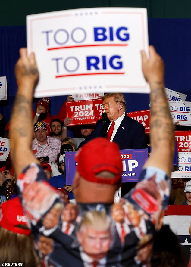 A supporter of Republican presidential candidate and former US President Donald Trump holds up a sign at a rally in Greensboro, North Carolina.