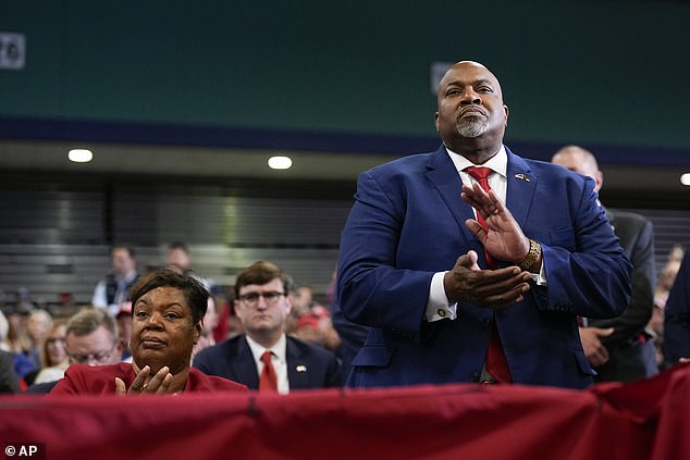 Governor Mark Robinson and his wife Yolanda listen as Republican presidential candidate, former President Donald Trump, speaks at a campaign rally.