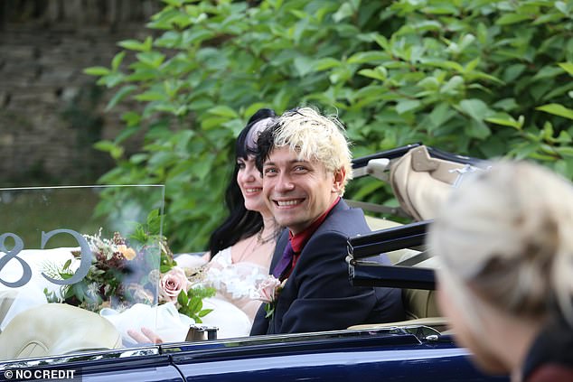Luke Storey smiles as the happy couple leaves after the wedding ceremony.
