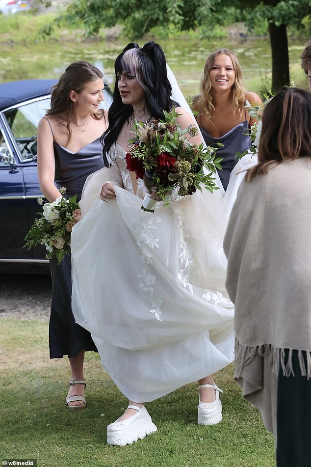 Charlotte surrounded by bridesmaids at her Cotswolds wedding