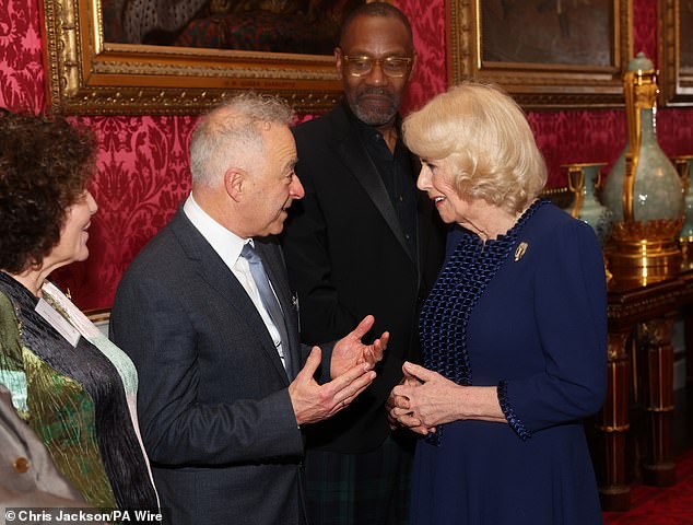 Camilla speaks to Frank Cottrell-Boyce during a reception at Buckingham Palace in London with finalists, judges and celebrity readers on February 28.