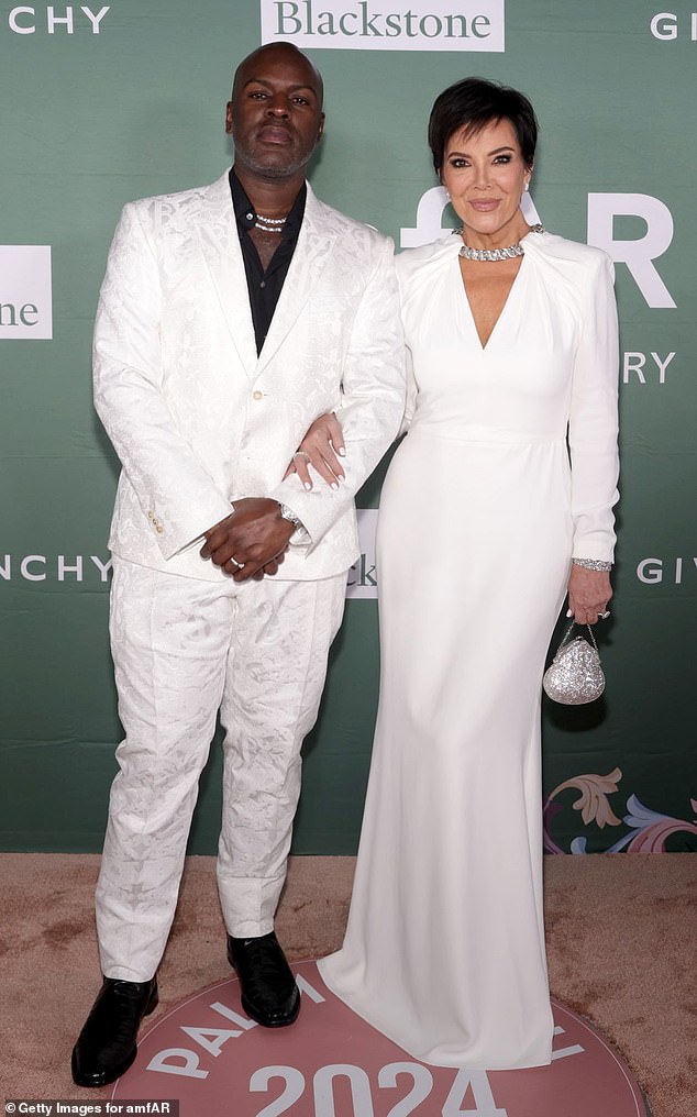 The Kardashian/Jenner matriarch wore a slinky dress with a stone-encrusted collar and plunging V-neckline.