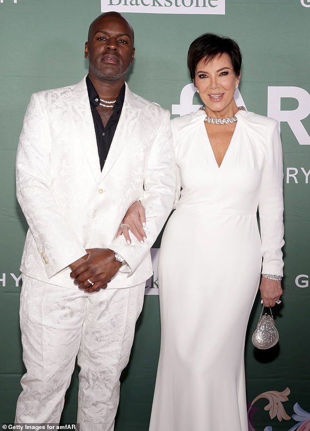 The Keeping Up With The Kardashians alum, 68, and the 43-year-old road manager dressed in white suits.