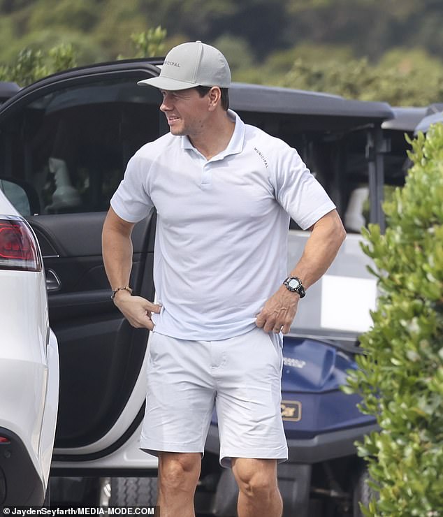 Mark opted for a classic golf ensemble that included a white polo shirt and matching pants.