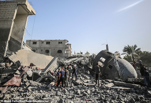 Palestinian children walk past the rubble of the al-Bukhari mosque in Deir al-Balah, central Gaza Strip, on March 2.