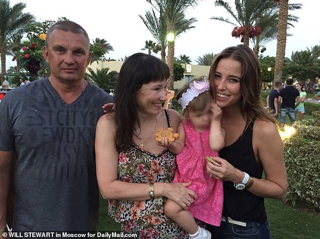 Ksenia Karelina, 33, pictured with her father Pavel, mother Liliya and younger sister, remains detained in Russia on charges of high treason.